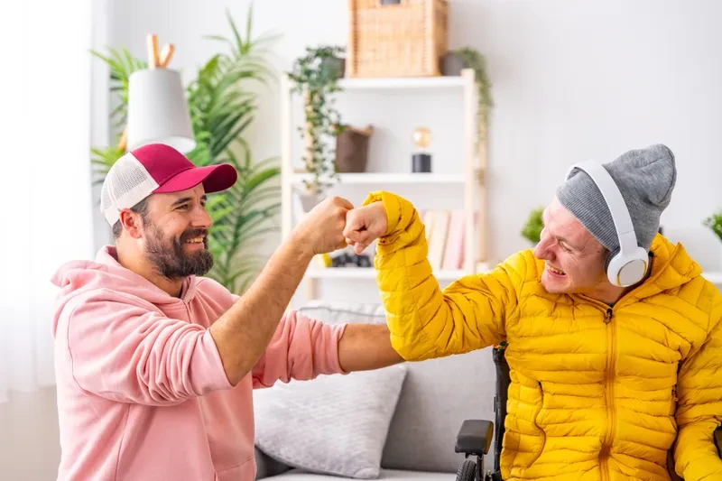 Staff member and client celebrating together with a fist bump